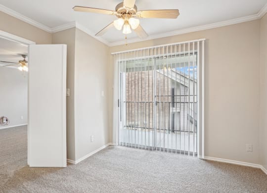 Unfurnished A4 floor plan living room with a door leading to balcony and a ceiling fan Noel on The Parkway in Dallas, TX