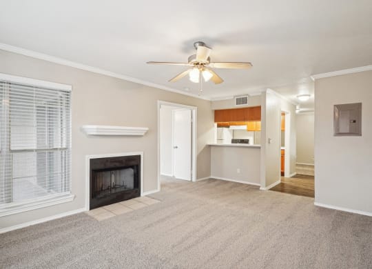 Unfurnished A4 floor plan living room with a fireplace and mantel, ceiling fan, and window Noel on The Parkway in Dallas, TX