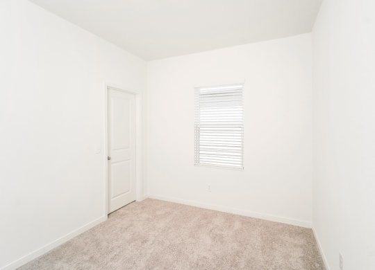 a bedroom with white walls and carpet at Beacon at Meridian, Texas
