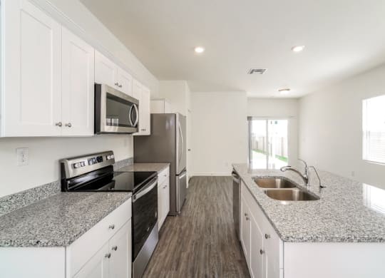a kitchen with granite countertops and stainless steel appliances at Beacon at Meridian, San Antonio, TX 78245