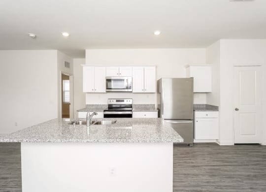 a kitchen with white cabinets and a granite counter top at Beacon at Meridian, Texas, 78245