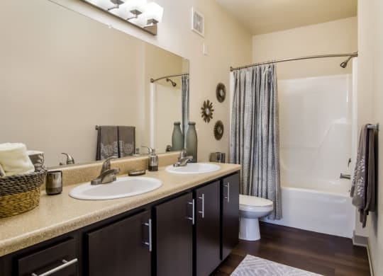 Bathroom with two sinks and a shower at Oakleaf Plantation in Jacksonville, FL