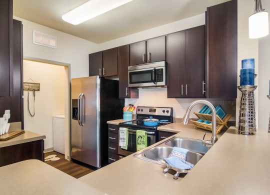 A Full kitchen with stainless steel appliances  at Oakleaf Plantation in Jacksonville, FL