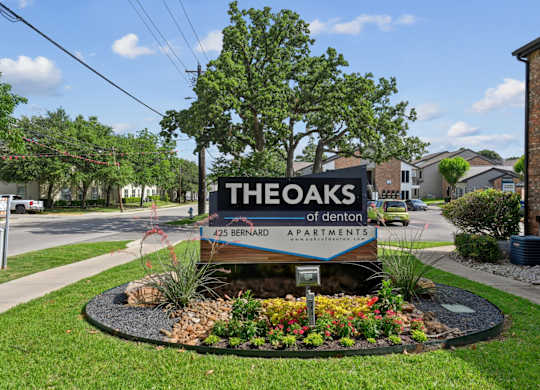 The entrance sign to The Oaks of Denton Apartments in Denton, TX