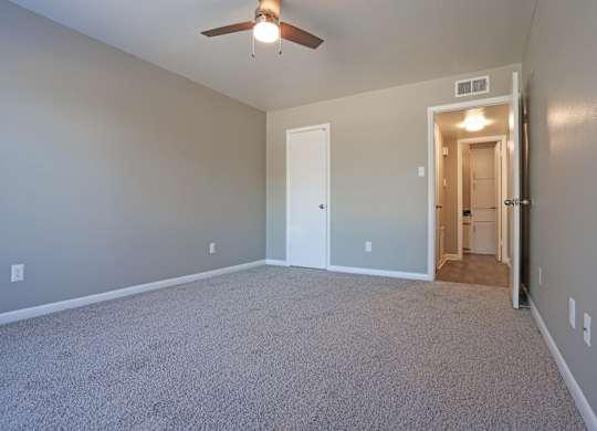 A bedroom with a ceiling fan and closet at Orleans Square in Shreveport, LA