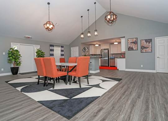 Vibrant chairs surround a table in a modern clubhouse at Orleans Square in Shreveport, LA