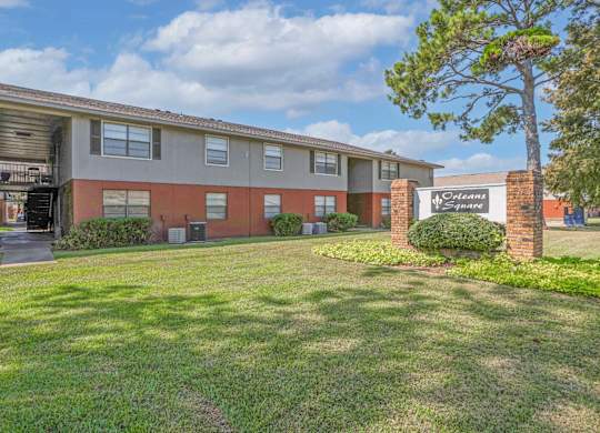 Apartment building with a sign that says "Orleans Square" in front of it at Orleans Square in Shreveport, LA