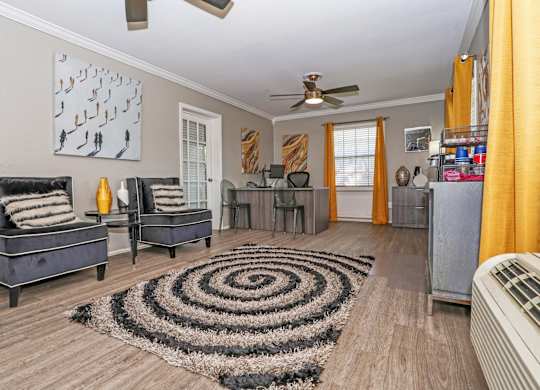 A leasing office with a black and white rug and a ceiling fan at Orleans Square in Shreveport, LA
