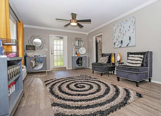 A leasing office with a black and white rug and a ceiling fan at Orleans Square in Shreveport, LA