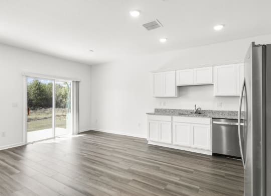 living room with a big window and white cabinets