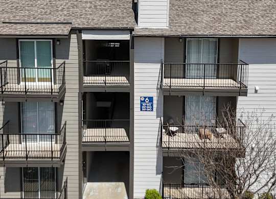 An apartment building with private balconies at The Park on Preston Apartments in Dallas, TX