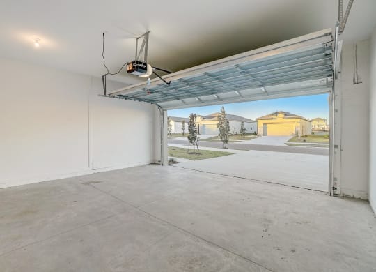 the interior of a garage with an open garage door