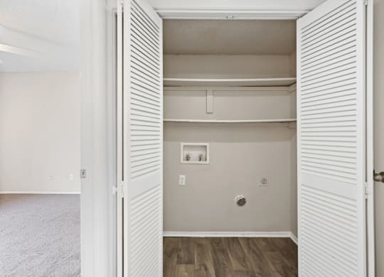 a bedroom with a medium sized closet and hardwood floors
