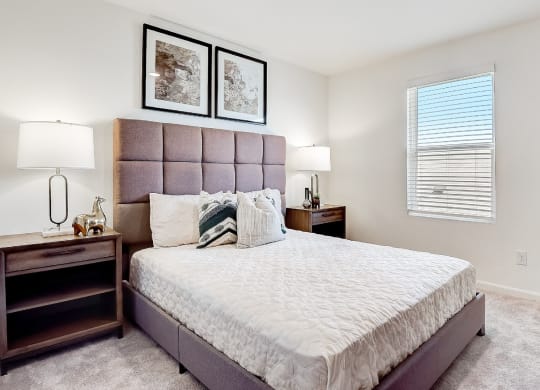 a bedroom with a large bed and some pictures on the wall