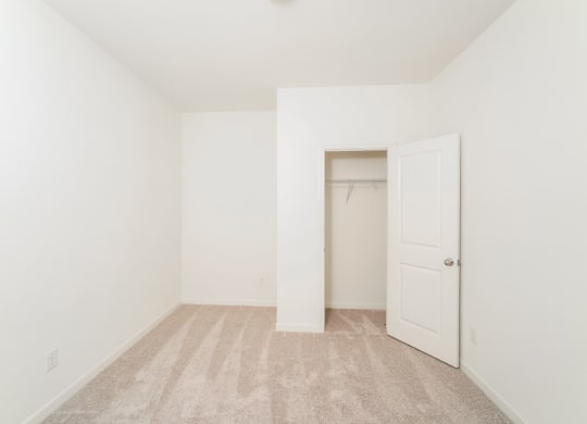 a bedroom with white walls and carpet at Beacon at Meridian, San Antonio Texas
