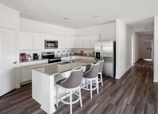 a kitchen with white cabinets and a granite counter top