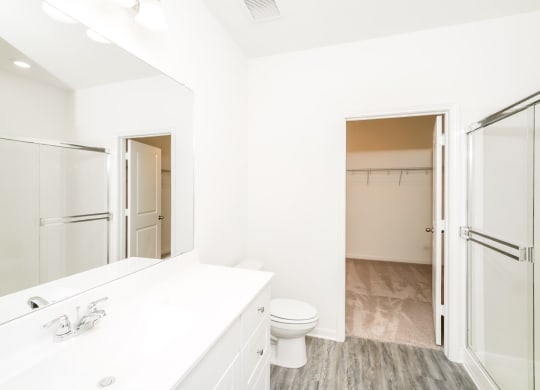 a bathroom with a white sink and toilet and a shower with a glass door at Beacon at Meridian, San Antonio Texas