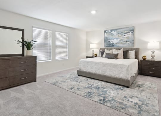 a bedroom with a bed and two dressers