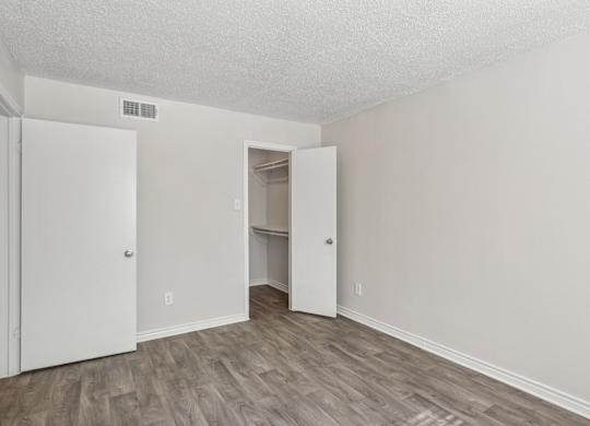 A room with a white door and a white closet.