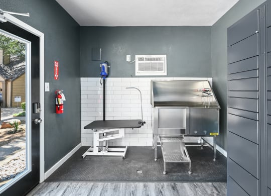 a kitchenette with a grill and a table and chairs