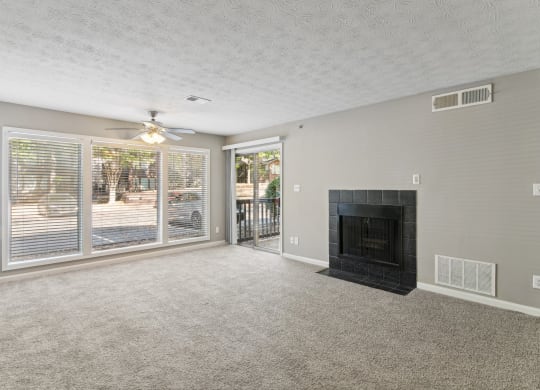 Bright living room with a fireplace and a ceiling fan at Oakley Run apartments in Smyrna, GA