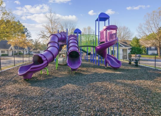 A playground with purple slides at Grand Reserve Columbus in Columbus, GA