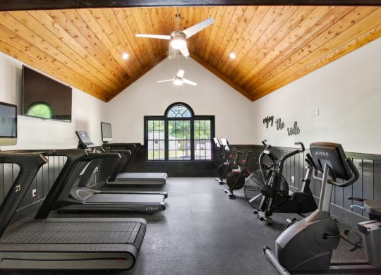 a gym with treadmills and elliptical machines at Grand Reserve at Columbus Apartments in Columbus, Georgia, GA