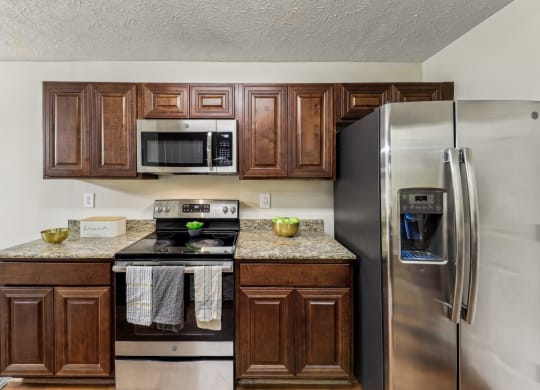 a kitchen with stainless steel appliances and wooden cabinets