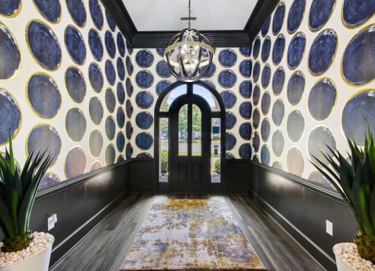 a hallway with plants at Grand Reserve at Columbus Apartments in Columbus, Georgia, GA