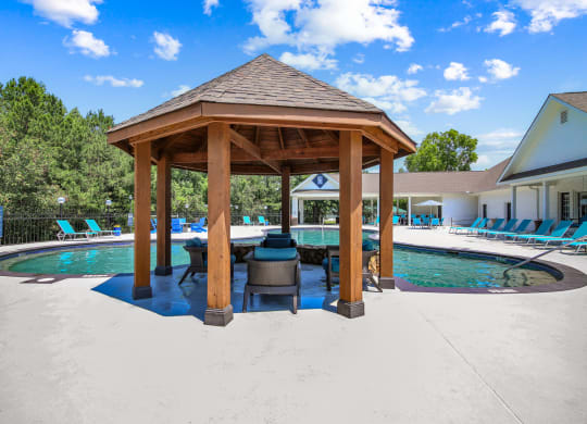 a gazebo with a grill next to a pool at Grand Reserve at Columbus Apartments in Columbus, Georgia, GA