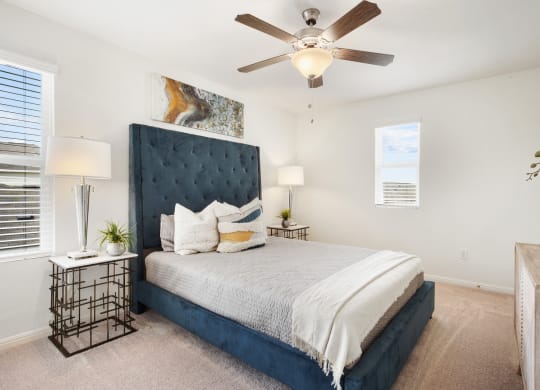 a bedroom with a large bed and a ceiling fanat Beacon at Ashley River Landing, Summerville, 29485
