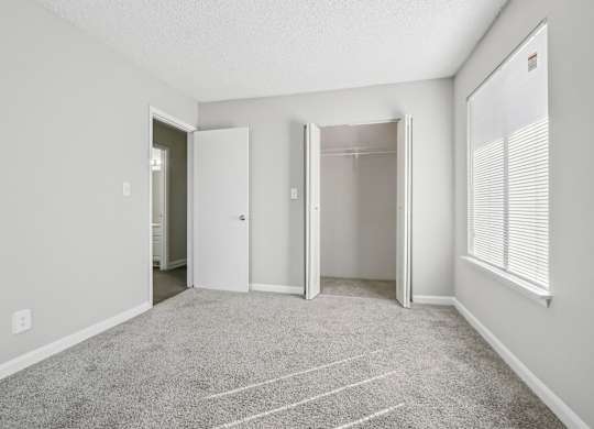 Second bedroom view of closet and entrance in C2b floor plan at Riverwood Crossing apartments in Roswell, GA.