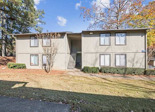 Exterior of our apartment buildings in autumn season at Riverwood Crossing apartments in Roswell, GA.