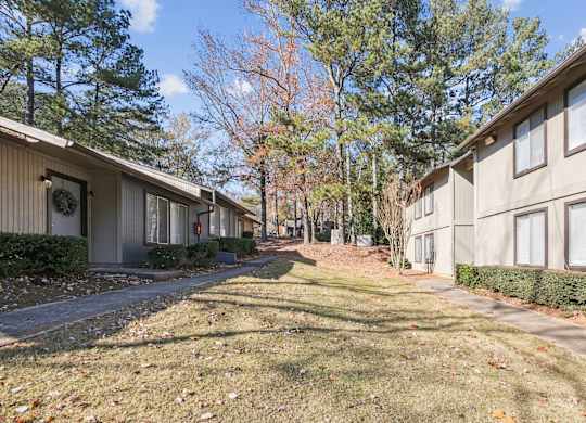 Lush landscaping in the beautiful autumn season at Riverwood Crossing apartments in Roswell, GA.