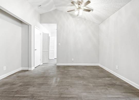 Large dining room with vaulted ceiling and ceiling fan in C2b floor plan at Riverwood Crossing apartments in Roswell, GA.