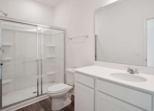 a white bathroom with a shower sink and toilet