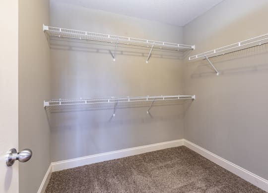 spacious walk in closets with shelves and hooks