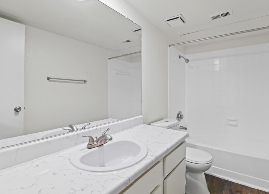 a bathroom with a sink toilet and shower