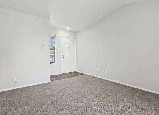 a bedroom with white walls and carpet