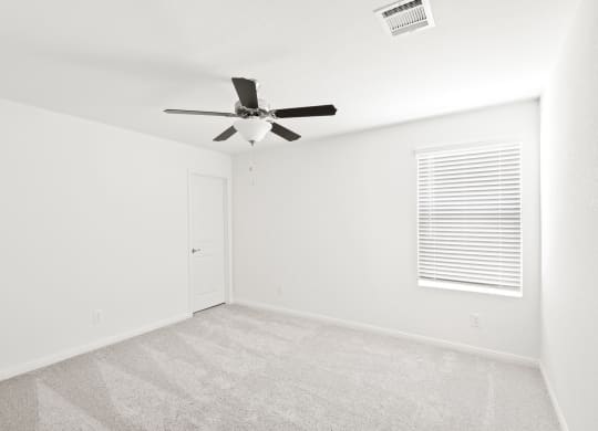 Sycamore spacious bedroom with ceiling fan and natural lighting at Beacon at Ashley River Landing in Summerville, SC