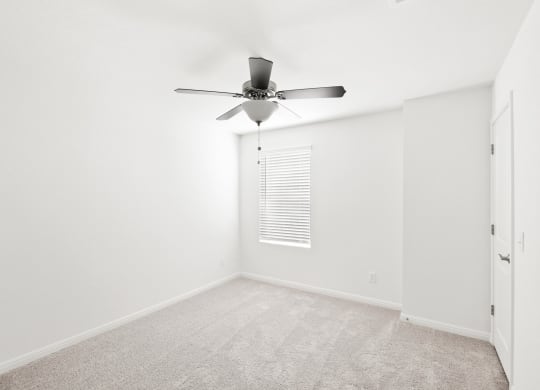 a bedroom with white walls and a ceiling fan at Beacon at Bunton Creek, Texas, 78640