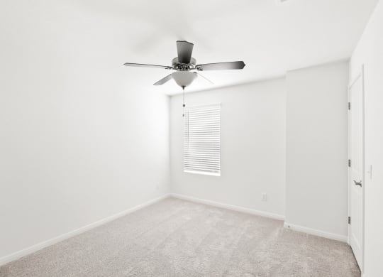 Sycamore bedroom with a ceiling fan and window at Beacon at Ashley River Landing in Summerville, SC
