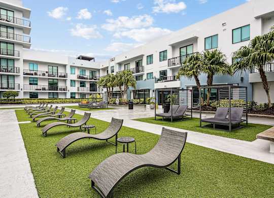 Poolside loungers in the pool area at Twenty2 West luxury apartments in Miami, FL