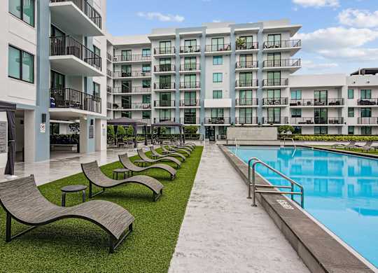 Poolside loungers in our resort-style pool area at Twenty2 West luxury apartments in Miami, FL