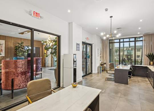 Leasing office with a white desks and chairs at Twenty2 West luxury apartments in Miami, FL
