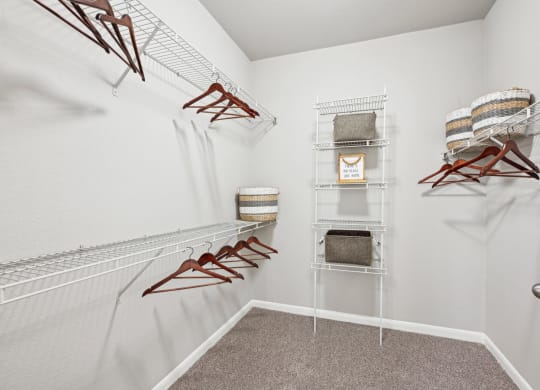 Walk-in closet with ample storage space at The Grand at Upper Kirby apartments in Houston, TX