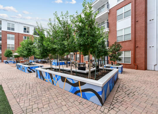 Modern outdoor seating area with decorative planters at The Grand at Upper Kirby apartments in Houston, TX