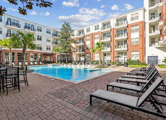 A pool with lounge chairs at The Grand At Upper Kirby in Houston, TX