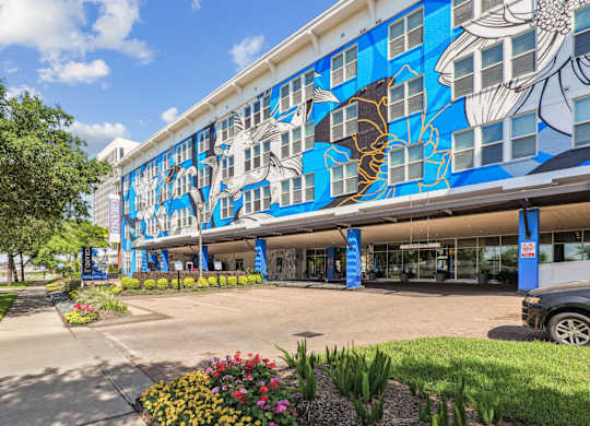 A building with a blue and white mural of fish on the side.