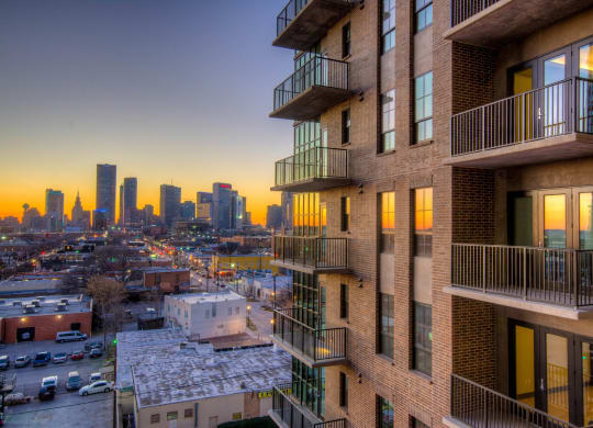 Exterior view of apartment building facing skyline of deep ellum